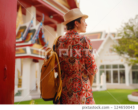 Woman Exploring Colorful Streets Near Buddhist Temples in Bangkok Woman Exploring Colorful Streets Near Buddhist Temples in Bangkok 124650043