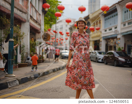 woman exploring streets of George Town, during Chinese New Year. 124650051