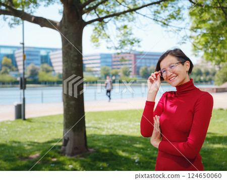 Woman in glasses stands in center of Frankfurt, Woman in glasses stands in center of Frankfurt, 124650060