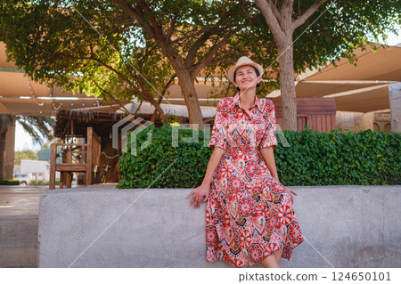 Young female tourist exploring iconic landmarks of the United Arab Emirates. Young female tourist exploring iconic landmarks of the United Arab Emirates. 124650101