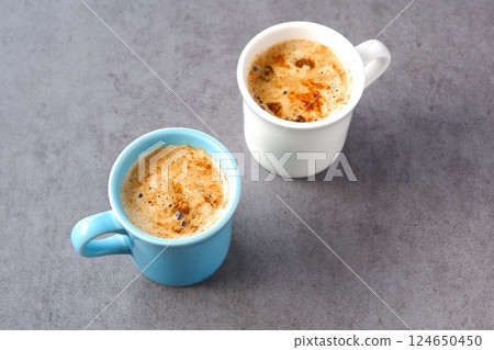 Two mugs filled with caffe latte, a coffee made from espresso and milk 124650450