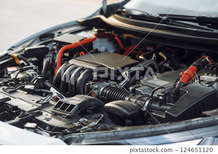 Close up view of the car's hood. Focused view of parts Close up view of the car's hood. Focused view of parts 124651120