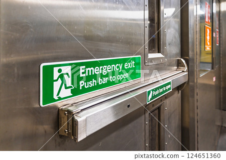 Close Up of Emergency Push Bar Exit in Stainless Steel Door in Subway Station 124651360