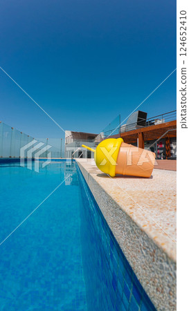 Refreshing summer drink by the pool on a sunny day Refreshing summer drink by the pool on a sunny day 124652410