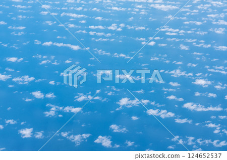 Blue sky with white clouds, flying above cloudy sky texture pattern, cloudscape blurred light Blue sky with white clouds, flying above cloudy sky texture pattern, cloudscape blurred light 124652537