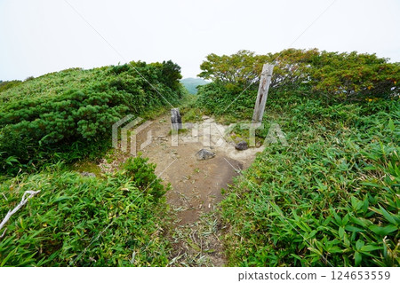The summit marker of Mount Jigami in the Iide mountain range The summit marker of Mount Jigami in the Iide mountain range 124653559