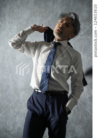 A gray-haired businessman wearing a jacket: Executive job change or start A gray-haired businessman wearing a jacket: Executive job change or start 124653610