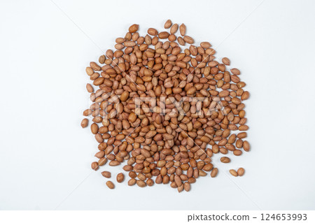 Raw brown peanuts close-up view from above on white background 124653993