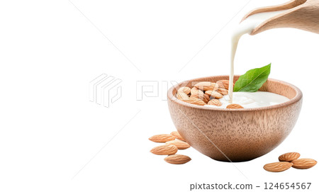 Healthy Organic Almonds Poured into Wooden Bowl with Milk Pouring Over Them 124654567