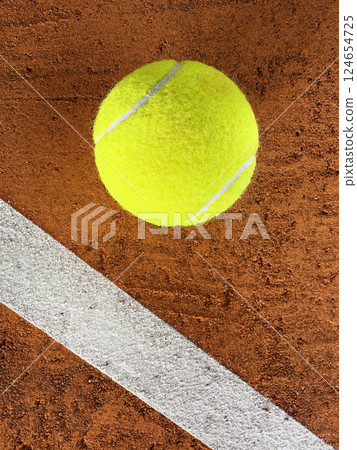 Tennis Ball on a Clay Court, Top Down View Tennis Ball on a Clay Court, Top Down View 124654725