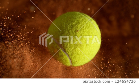Freeze Motion Detail Shot of Flying Tennis Ball with Clay Explosion Freeze Motion Detail Shot of Flying Tennis Ball with Clay Explosion 124654726
