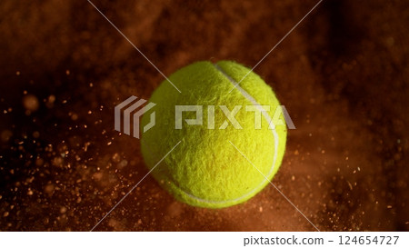 Freeze Motion Detail Shot of Flying Tennis Ball with Clay Explosion Freeze Motion Detail Shot of Flying Tennis Ball with Clay Explosion 124654727