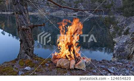 Beautiful Crackling Campfire at Pine Tree by the Lake , Sunrise 124654820