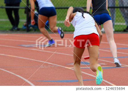 Track Athletes Compete in Sprint Relay Race During Afternoon Meet 124655694