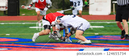 Lacrosse Players Compete for Possession on the Field During a Faceoff 124655734