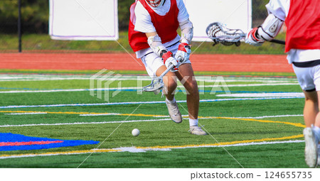 Lacrosse Players Competing for the Ball on the Field During a game Lacrosse Players Competing for the Ball on the Field During a game 124655735