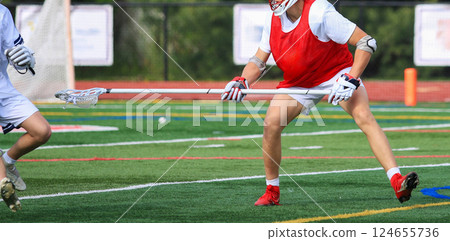 Lacrosse Players in Action on a Field 124655736