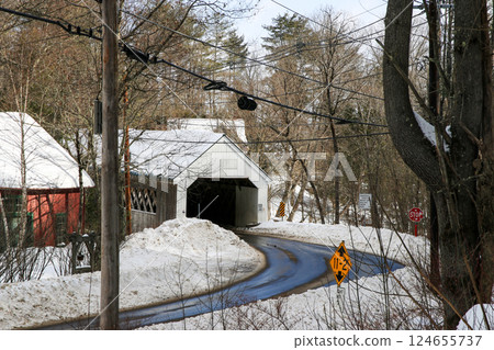Looking Down at a Snowy Road Leading to the Historic Williamsville Covered Bridge in Vermont 124655737