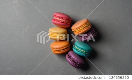 Assorted Colorful Macarons Arranged on a Gray Stone Background 124656250