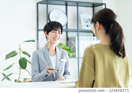 A female planner explaining to a young woman 124656573