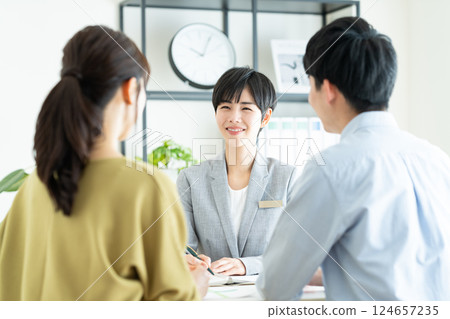 A planner selling to a young couple A planner selling to a young couple 124657235