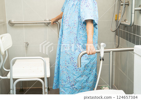 Asian elderly woman patient use toilet bathroom handle security in nursing hospital, healthy strong medical concept. Asian elderly woman patient use toilet bathroom handle security in nursing hospital, healthy strong medical concept. 124657384