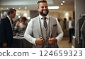 Joyful adult man adjusting a wedding suit in a tailoring studio 124659323
