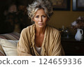 Elderly Woman Sitting on Sofa at Home with a Worried Expression 124659336