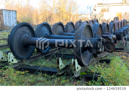 Old train wheels rest on supports in deserted yard, awaiting inspection is under restoration 124659539
