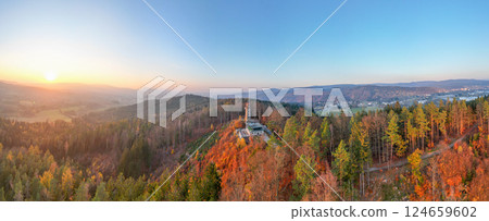 The lookout tower on Prosec Ridge offers a stunning view during an autumn sunset, showcasing vibrant foliage and the picturesque landscape near Jablonec nad Nisou in Czechia. 124659602