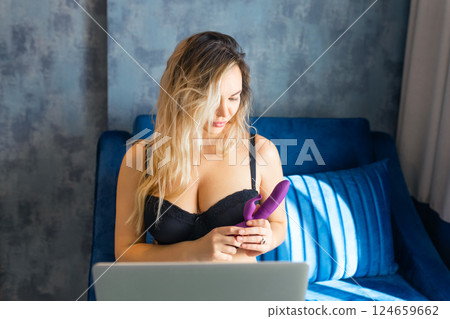 Attractive young woman in lingerie with vibrator and laptop having virtual sex at home Attractive young woman in lingerie with vibrator and laptop having virtual sex at home 124659662