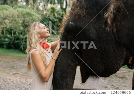 beautiful girl with smiling elephant, elephant village, bali 124659666