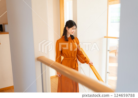 Young woman walking down the stairs 124659788