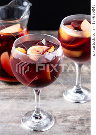 Refreshing Summer Citrus Fruit Sangria in crystal jar on wooden table Refreshing Summer Citrus Fruit Sangria in crystal jar on wooden table 124659845