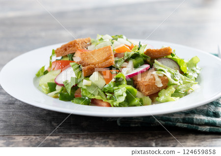 Fattoush salad, Traditional Lebanese Salad on wooden table Fattoush salad, Traditional Lebanese Salad on wooden table 124659858