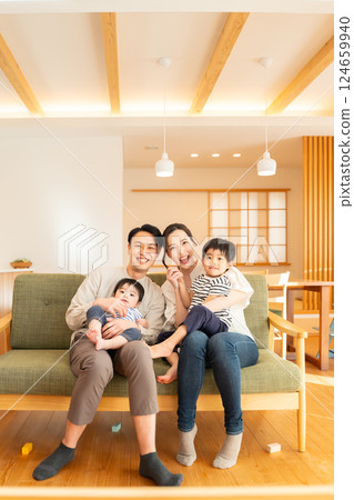 Living room, family of four looking at camera 124659940