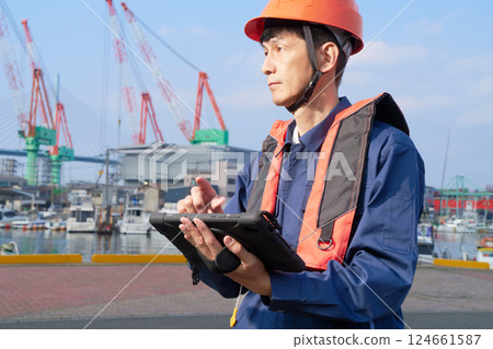 Male worker engaged in port work Male worker engaged in port work 124661587