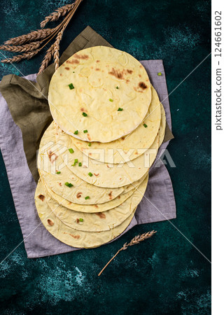 Lavash flat bread on green background Lavash flat bread on green background 124661602