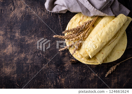 Lavash flat bread on green background Lavash flat bread on green background 124661624