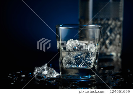 Crystal clear vodka or gin in a glass with ice. 124661699
