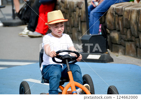 boy driving quad bike, four wheel cycle car, spring brightly morning, sunny day. High quality photo 124662000