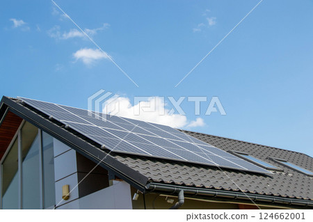 House roof with photovoltaic modules. Historic farm house with modern solar panels on roof and wall High quality photo 124662001
