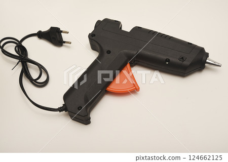 Black glue gun on a white background. Black glue gun on a white background. 124662125