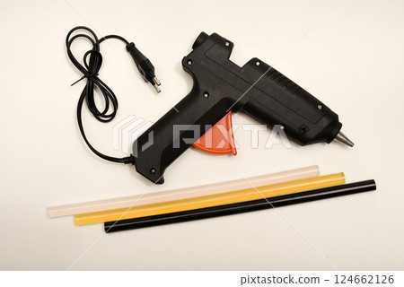 Black glue gun on a white background. 124662126