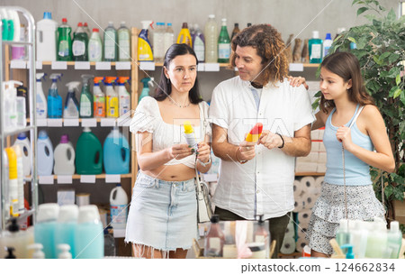 Family choosing insect repellents for summer outdoor trip in store Family choosing insect repellents for summer outdoor trip in store 124662834