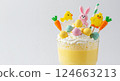 Easter dessert drink glass. Candy eggs chick bunny decoration. Holiday party food blog. Still life bright white photo 124663213