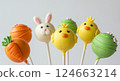 Easter themed cake pops treats. Bunny chick carrot designs. Holiday desserts party fun food. Macro bright colorful white background 124663214