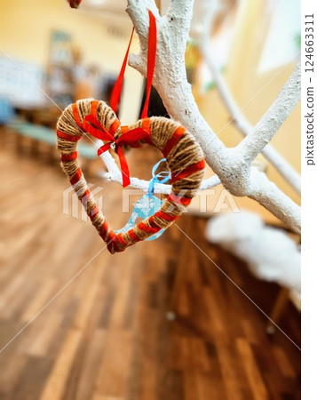 valentine's heart decorative hanging on tree. Red ribbon. Love symbol valentine's heart decorative hanging on tree. Red ribbon. Love symbol 124663311