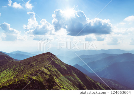 Summer mountain landscape with rolling green hills Summer mountain landscape with rolling green hills 124663604