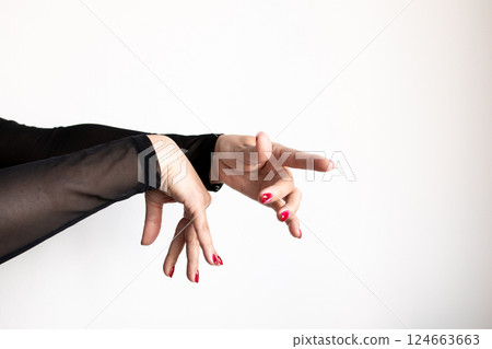 Expressive female hands with red nails in dance pose against white background 124663663